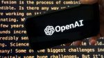 FILE - The OpenAI logo appears on a mobile phone in front of a screen showing part of the company website in this photo taken on Nov. 21, 2023 in New York. (AP Photo/Peter Morgan, File)